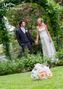 Bouquet with bride and groom in the background