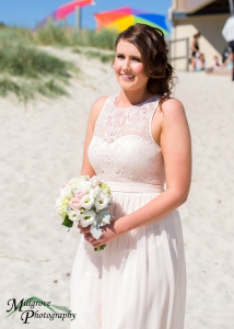 Beautiful bridesmaid walking down Carrum Beach