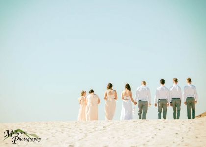 Bridal party walking along the beach in Melbourne