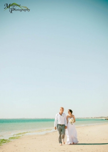 Bride Rachel and Groom Phill walking on the beach at Carrum, Melbourne