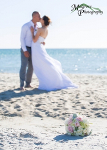 Bride Rachel and Groom Phill kissing in the background of the bouquet