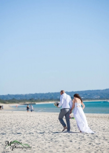 Bride Rachel and Groom Phill walking on the beach