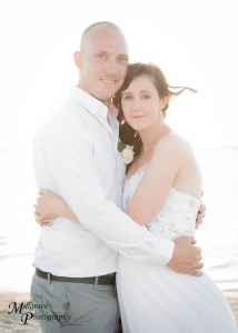 Bride and groom with the sunset behind them