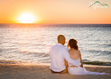 Bride and groom on the beach with the sunset
