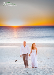Bride and groom walking on Carrum beach at sunset