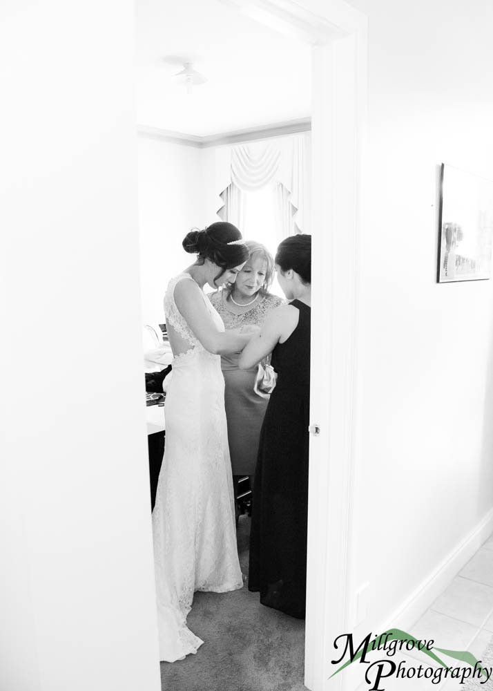 Three women hugging before a wedding