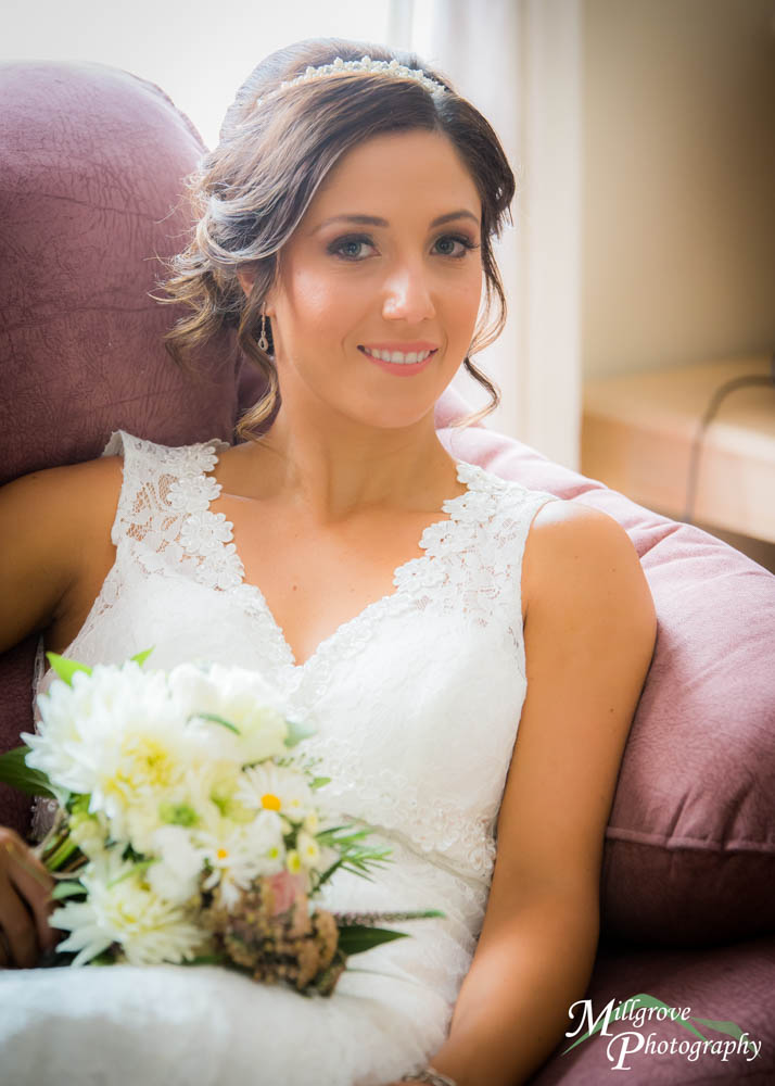 A bride sitting on a marone sofa