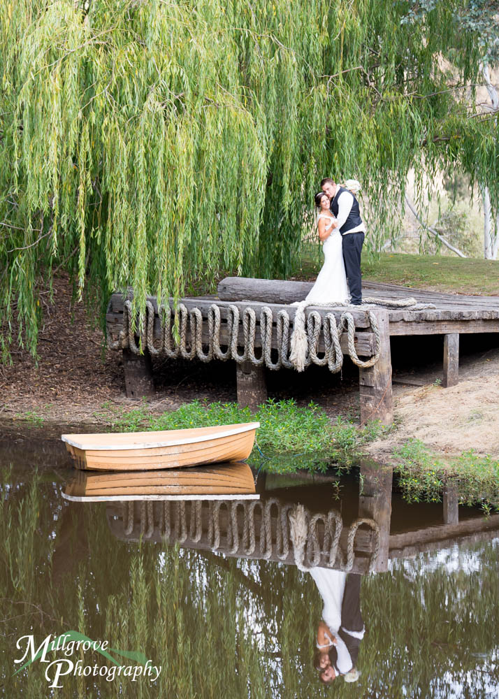 A bride and groom by the lake at Inglewood Estate wedding venue