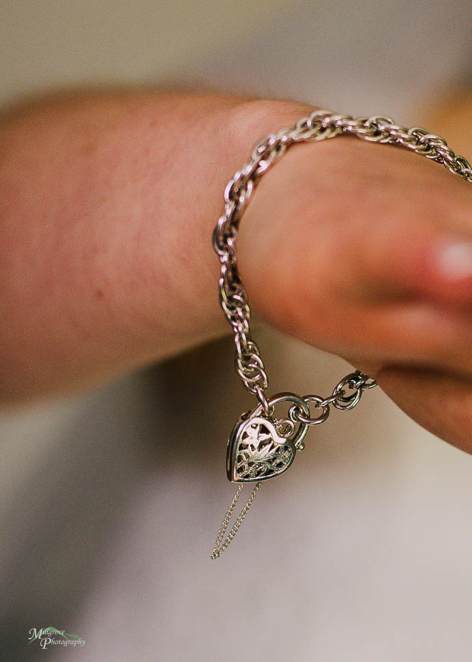 Heart shaped locket on bride's hand