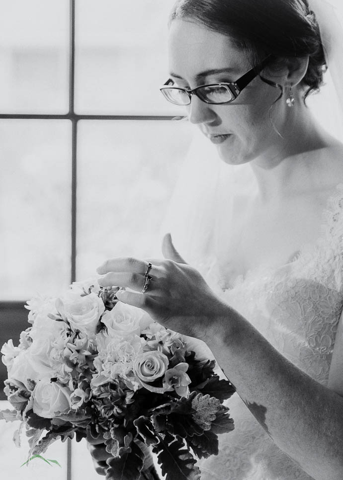 Bride looking down at flowers
