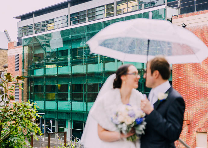 Bride and groom outside buildings at RMIT