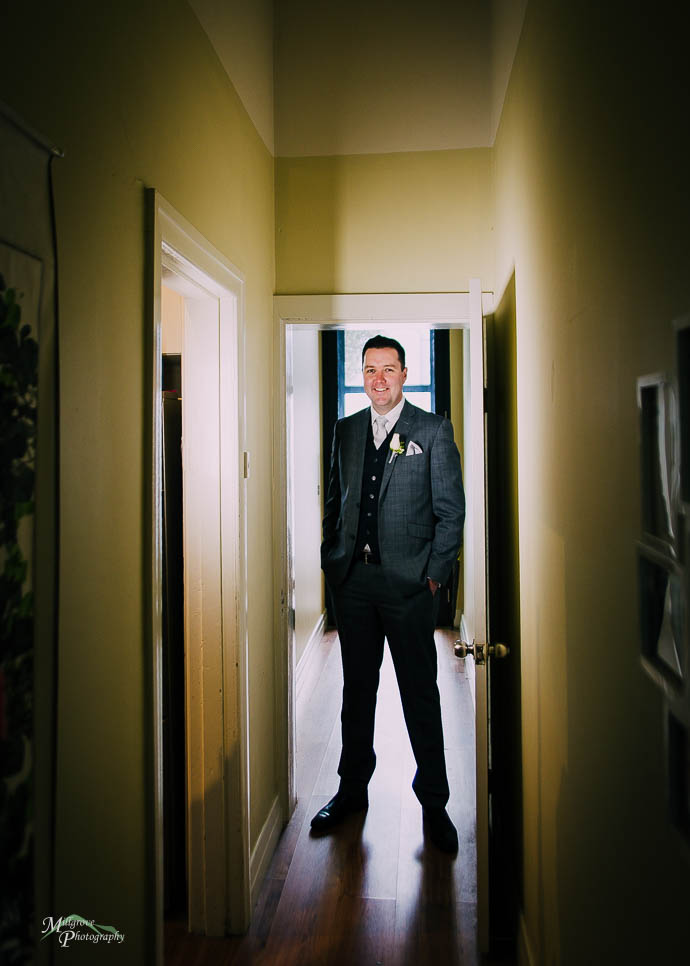 Groom lit in a dark corridor