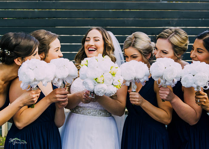 Bride and bridesmaids laughing