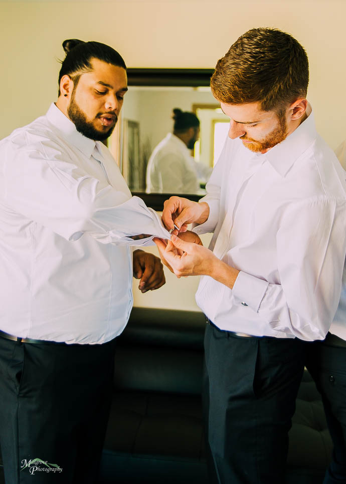 Best man helping put cufflinks on