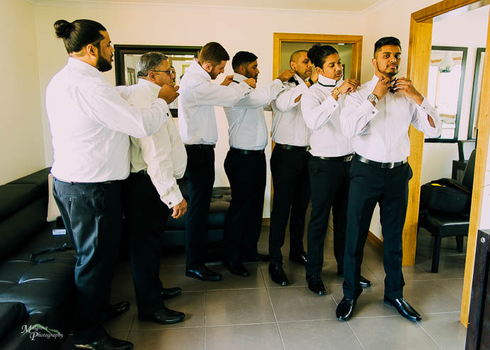 Groomsmen doing up their ties