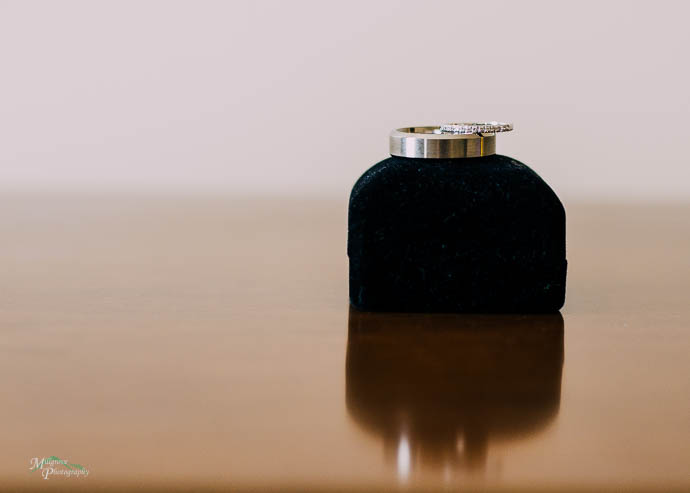 Wedding rings balancing on ring box