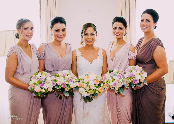 Bride and bridesmaids in lilac and pink dresses