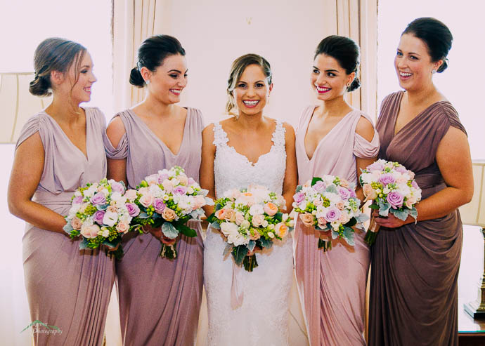 Bride and bridesmaids in lilac and pink dresses