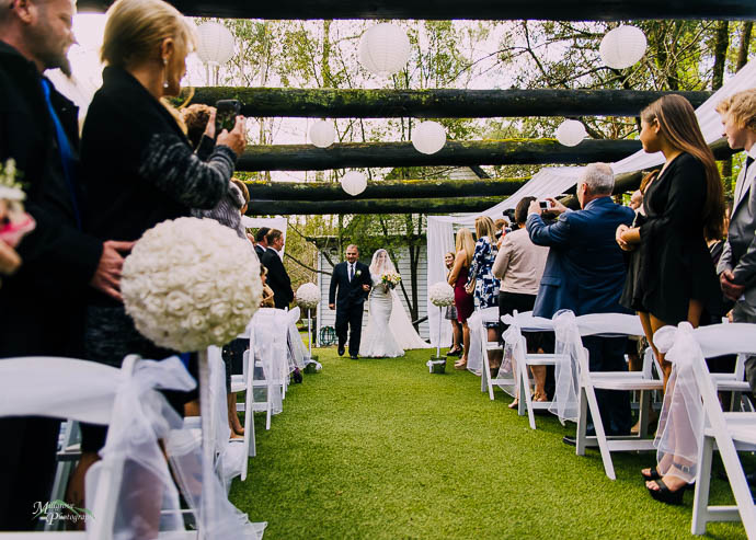Bride and father walking down the aisle at Chateau Wyuna