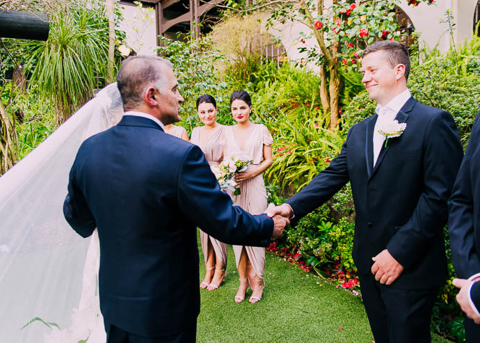 Groom and cride's father shaking hands