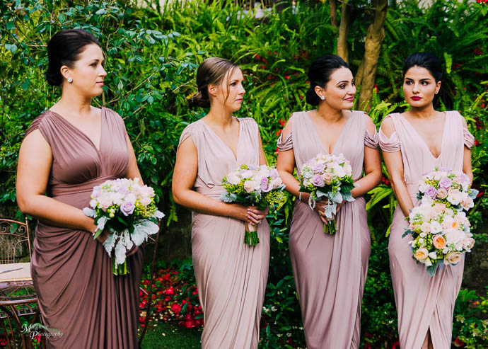 Bridesmaids in pink and lilac dresses