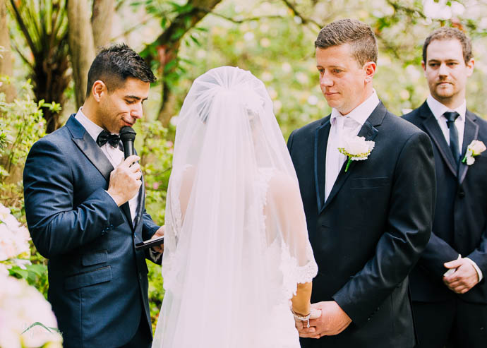 Bride and groom with celebrant during ceremony