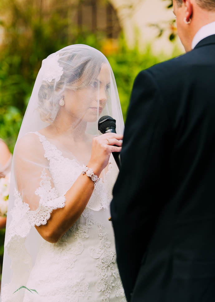 Bride speaking into microphone during ceremony