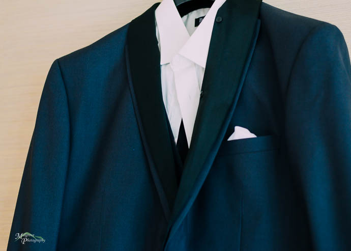 Black suit and white shirt on a hanger