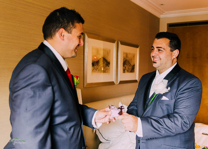 Groom and groomsman shaking hands