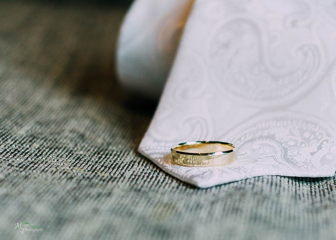 Wedding ring on a groom's white tie