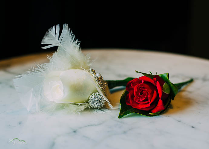 A white and red rose on a marbel table