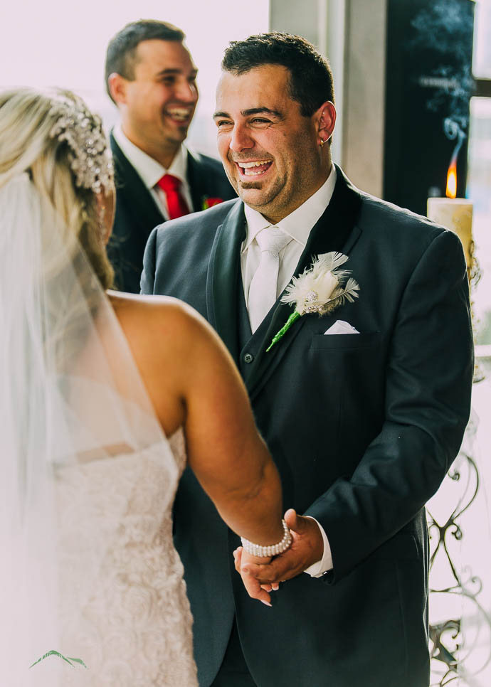 Laughing groom at Wedding ceremony at All Smiles Melbourne Waterf