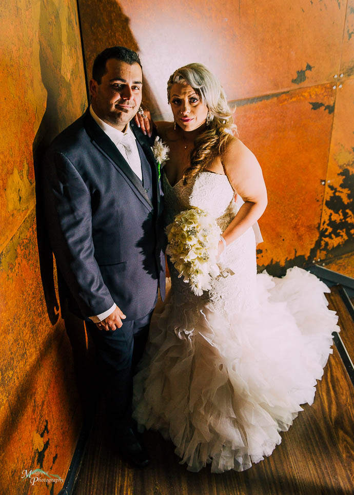 Bride and groom on the stairwell at All Smiles Melbourne Waterfr