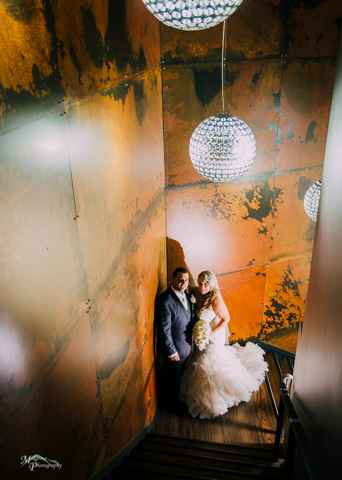 Bride and groom on the stairwell at All Smiles Melbourne Waterfr