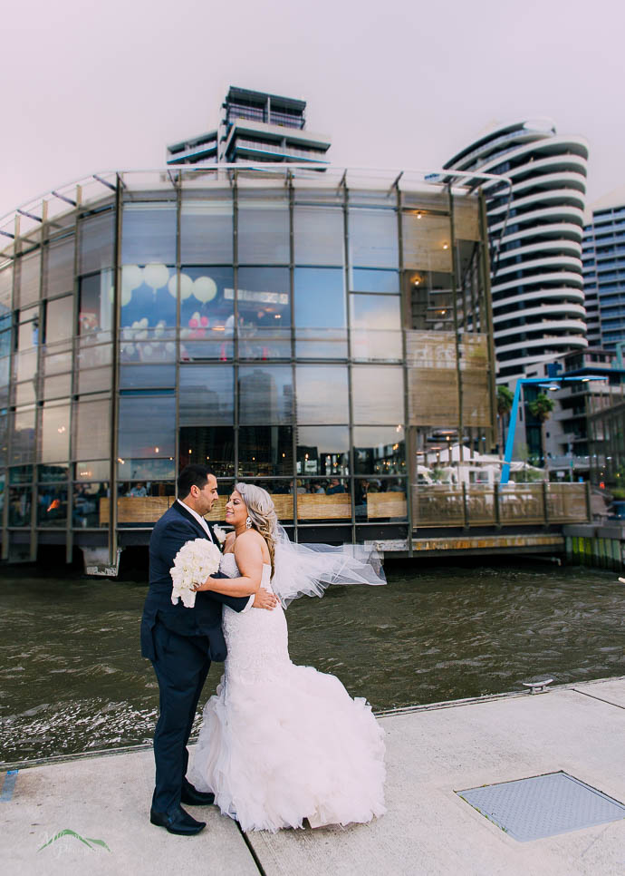 Bride and groom outside All Smiles Melbourne Waterfront on a co