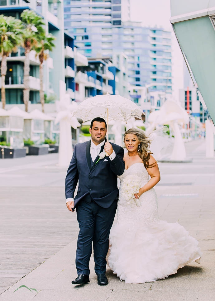 Bride and groom outside All Smiles Melbourne Waterfront on a co