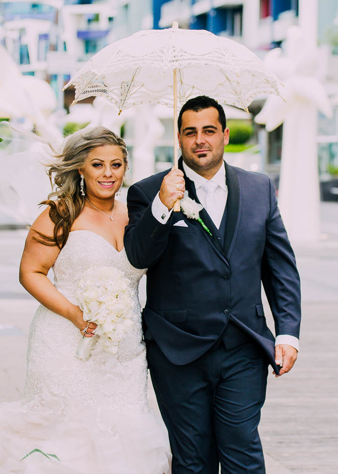 bride and groom outside All Smiles Melbourne Waterfront on a co