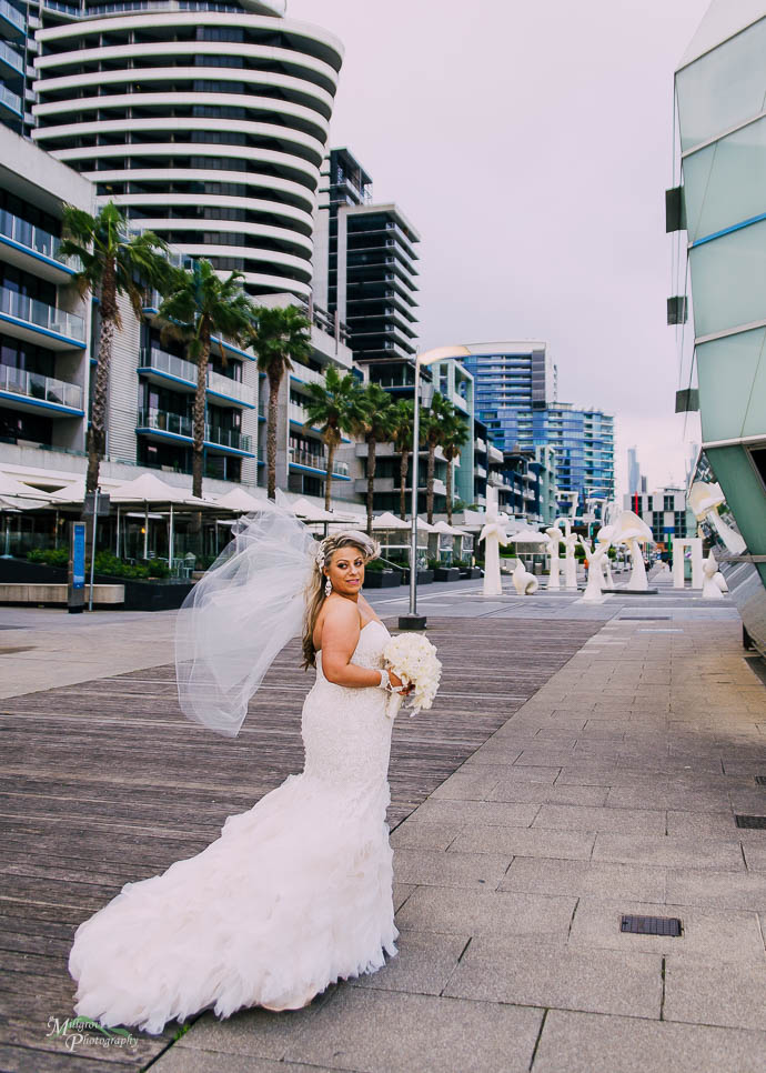 Bride's veil being blown by the wind at Docklands, Melbourne