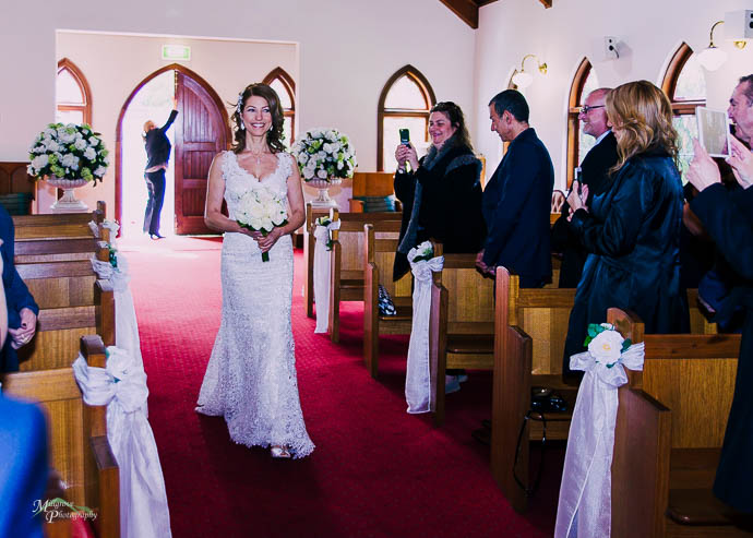 Bride walking down the aisle in the chapel at Ballara Receptions