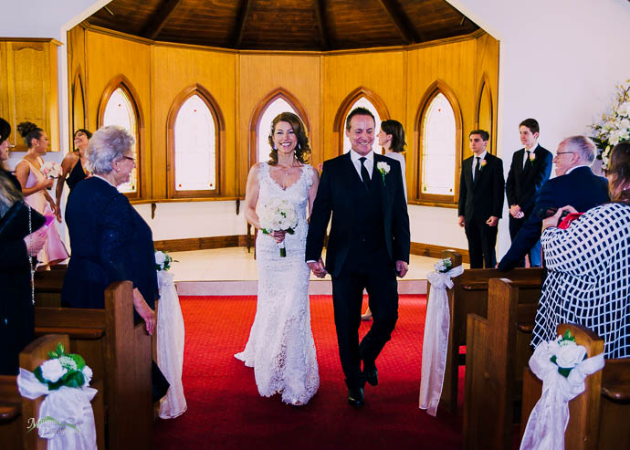 Bride and groom walking down the aisle