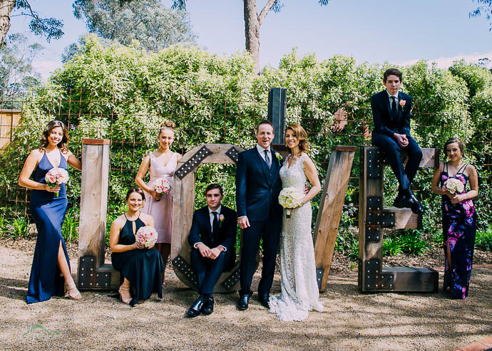 Bridal party arranged on giant LOVE letters