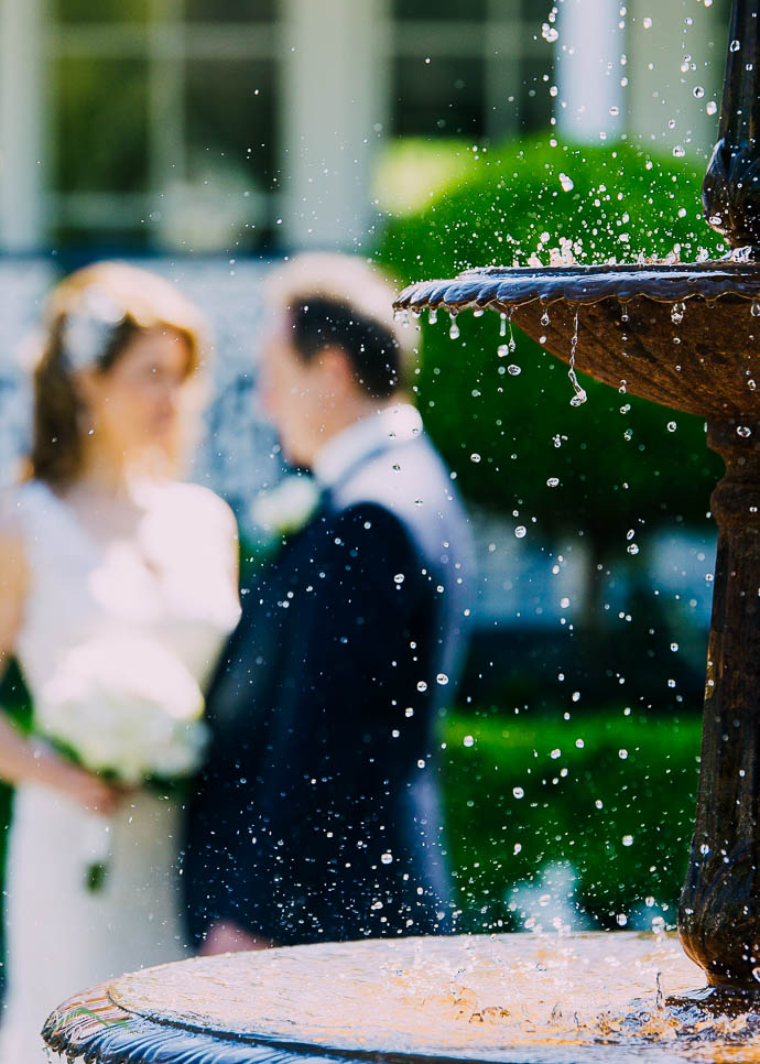 Raindrops frozen with bride and groom in the background