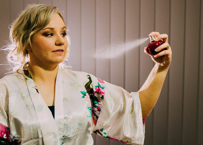 Bride spraying perfume