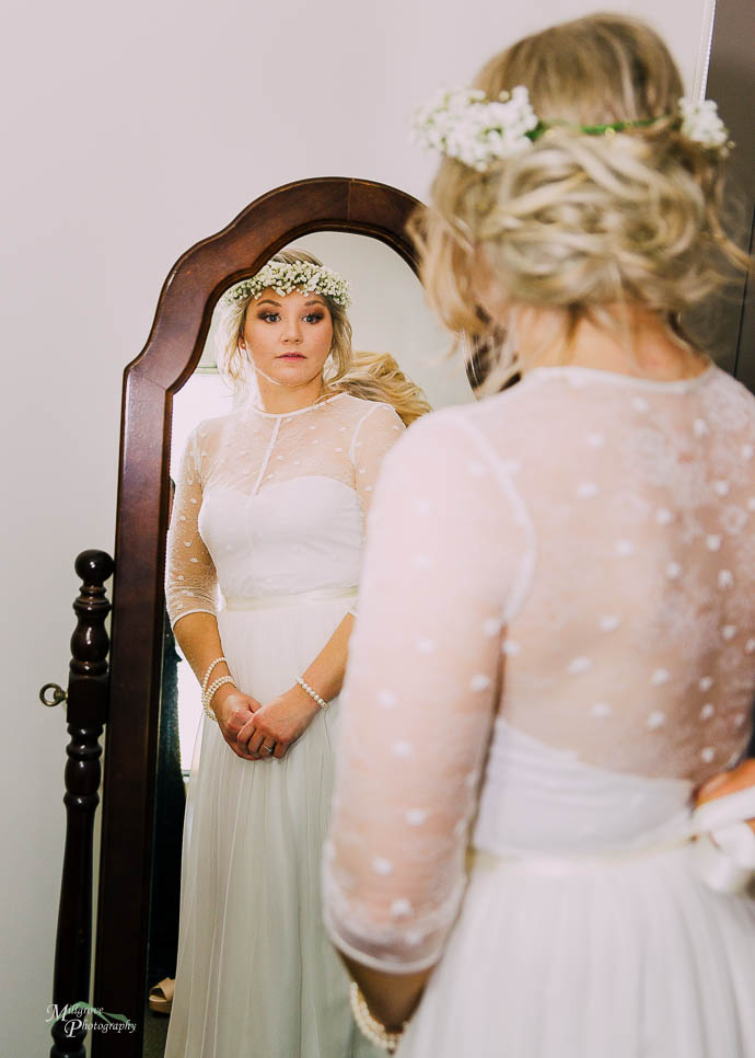 Bride looking at herself in the mirror