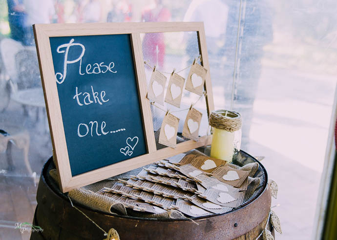 Sign at a wedding saying "Please take one"