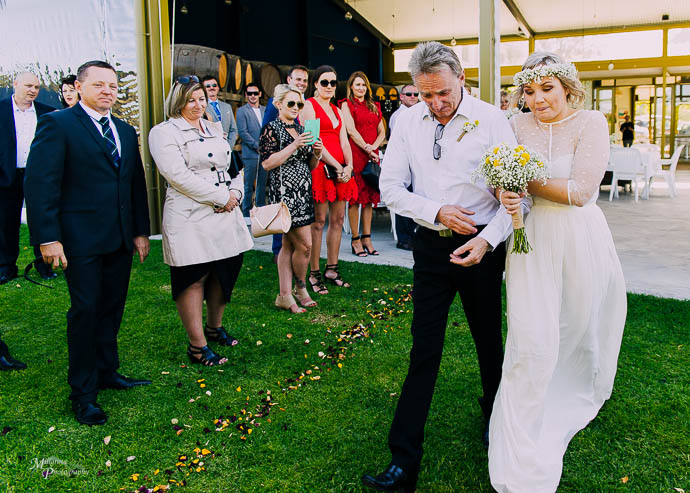 Bride and father walking down the aisle at Two Brookes Bar