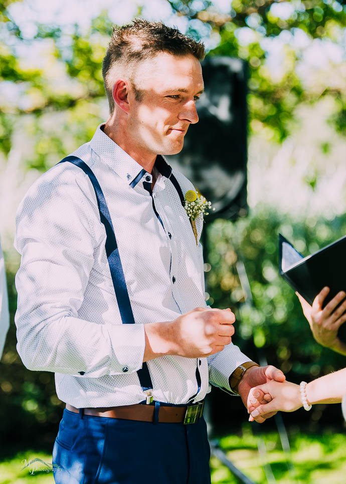 Groom holding ring during Wedding ceremony at Two Brookes Bistro
