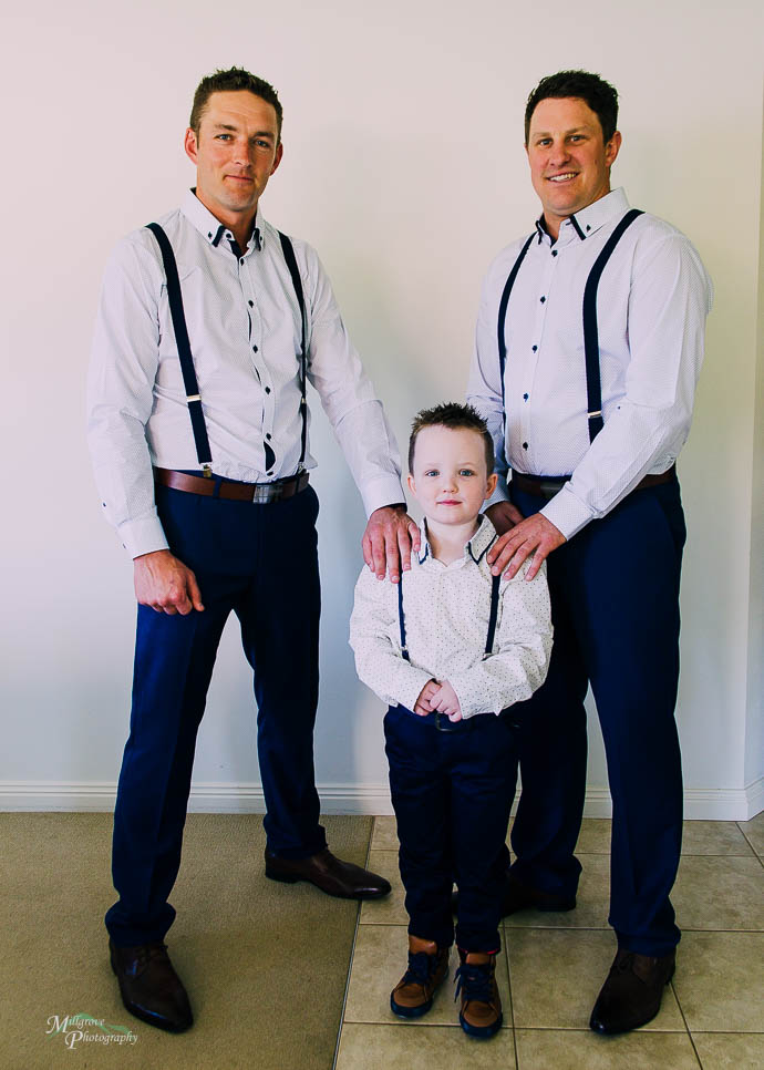 Two groomsmen with little page boy