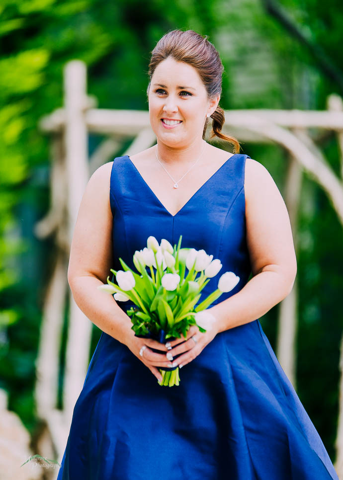Bridesmaid walking down the aisle at Lake House, Daylesford