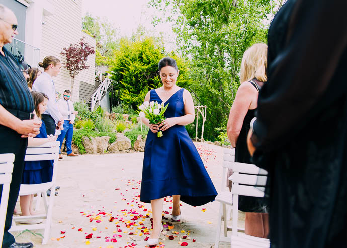 Bridesmaid walking down the aisle at Lake House, Daylesford